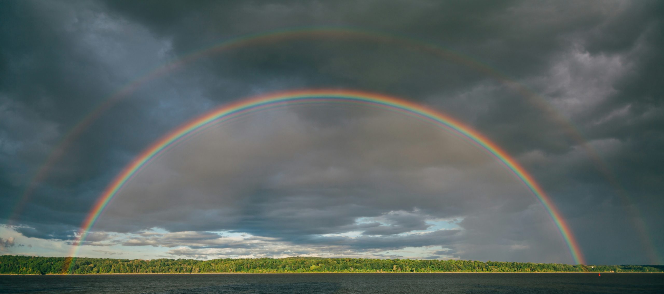 Double rainbow across a stormy sky